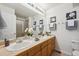 Bathroom features dual sinks, a large mirror, and tasteful décor at 12860 E Dickensen Pl, Aurora, CO 80014