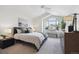 Bright bedroom features a vaulted ceiling, a large window, and neutral carpet and decor at 12860 E Dickensen Pl, Aurora, CO 80014