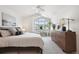 Bright bedroom features a vaulted ceiling, a large window, and neutral carpet and decor at 12860 E Dickensen Pl, Aurora, CO 80014