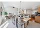 Bright dining area with stylish lighting, open to the kitchen and living room at 12860 E Dickensen Pl, Aurora, CO 80014