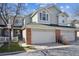 Inviting townhome with a two-car garage and well-maintained landscaping at 12860 E Dickensen Pl, Aurora, CO 80014