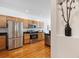 Kitchen featuring stainless steel appliances, wooden cabinets, and hardwood floors at 12860 E Dickensen Pl, Aurora, CO 80014