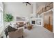 Inviting living room with high ceilings, a cozy fireplace, and large windows at 12860 E Dickensen Pl, Aurora, CO 80014