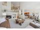 Open-concept living area featuring a fireplace and views of the dining area at 12860 E Dickensen Pl, Aurora, CO 80014