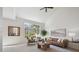 Sunlit living room features neutral colors, vaulted ceiling, and a large window at 12860 E Dickensen Pl, Aurora, CO 80014