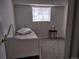 Bedroom with a white bed and a window at 10211 Ura Ln # 101, Thornton, CO 80260