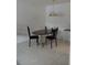 Dining area featuring a dark wood table with chairs under a pendant light at 10211 Ura Ln # 101, Thornton, CO 80260