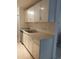 Kitchen featuring a stainless steel dishwasher and white countertops and cabinets at 10211 Ura Ln # 101, Thornton, CO 80260