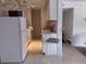 Bright kitchen features white appliances and cabinetry at 10211 Ura Ln # 101, Thornton, CO 80260