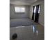The living room offers a spacious layout with neutral carpeting at 10211 Ura Ln # 101, Thornton, CO 80260