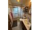Cozy bathroom featuring a shower with sliding glass doors and a stylish vanity with good lighting at 8278 Cherokee St, Denver, CO 80221