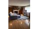 Bright living room with a comfortable gray sectional sofa, modern entertainment center and hardwood floor at 8278 Cherokee St, Denver, CO 80221