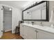 Bright bathroom with double sink vanity, large mirror, and shower at 9700 E Iliff Ave # 81, Denver, CO 80231