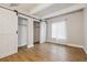 Bedroom with wood floors, barn doors, and closet storage at 9700 E Iliff Ave # 81, Denver, CO 80231
