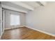 Bedroom featuring wood floors, a window, and a barn door closet at 9700 E Iliff Ave # 81, Denver, CO 80231
