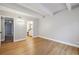 This bright bedroom features wood floors and an ensuite bathroom entrance at 9700 E Iliff Ave # 81, Denver, CO 80231