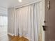 Walk-in closet with curtain, lighting, and wood floor at 9700 E Iliff Ave # 81, Denver, CO 80231