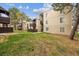 Apartment complex featuring well-maintained lawn and multiple units with wood balcony features at 9700 E Iliff Ave # 81, Denver, CO 80231