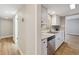 Modern kitchen featuring white cabinets, stainless steel appliances, and wood floors at 9700 E Iliff Ave # 81, Denver, CO 80231