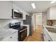 Well-equipped kitchen with stainless steel appliances, white cabinets, and marble countertops at 9700 E Iliff Ave # 81, Denver, CO 80231