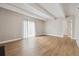 Open-concept living room featuring wood floors, beams, and a light-filled atmosphere at 9700 E Iliff Ave # 81, Denver, CO 80231