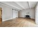 Open-concept living room with fireplace, sliding barn door, and neutral color scheme at 9700 E Iliff Ave # 81, Denver, CO 80231