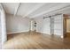 Bright living room showcasing open design, light wood floors, and modern sliding door at 9700 E Iliff Ave # 81, Denver, CO 80231