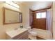 Bathroom featuring tiled shower over tub, vanity and framed mirror at 11085 Clarkson St, Northglenn, CO 80233