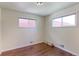 Comfortable bedroom offers natural light from two windows and sleek floors at 11085 Clarkson St, Northglenn, CO 80233