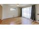 Bright living room features hardwood floors, large window with curtains, and fresh paint at 11085 Clarkson St, Northglenn, CO 80233