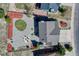 Aerial view of a home with a spacious backyard featuring a firepit, hot tub, landscaping, and rock coverage at 17050 Park Trail Dr, Monument, CO 80132