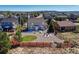 Aerial view of home's expansive backyard, showcasing a firepit, patio, lawn, and hot tub area at 17050 Park Trail Dr, Monument, CO 80132