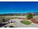 Spacious backyard featuring a stone patio area, landscaping, and mountain views at 17050 Park Trail Dr, Monument, CO 80132