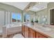 Bright bathroom with tub, separate shower, double sinks, and natural light at 17050 Park Trail Dr, Monument, CO 80132