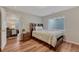 Bedroom with neutral colors and hardwood flooring, with an open doorway to living space at 17050 Park Trail Dr, Monument, CO 80132