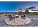 Inviting backyard firepit with stone surround, seating, and scenic mountain views creates a relaxing outdoor space at 17050 Park Trail Dr, Monument, CO 80132