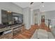 Hallway with hardwood floors, leading to bathroom, bedroom, and stairs with view of living room at 17050 Park Trail Dr, Monument, CO 80132