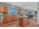 Well-appointed kitchen with wood cabinets, granite counters, eat in area, and scenic view at 17050 Park Trail Dr, Monument, CO 80132