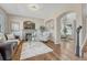 Inviting living room with a stone fireplace, arched doorways, and hardwood floors at 17050 Park Trail Dr, Monument, CO 80132
