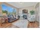 Bright living room featuring a stone fireplace, hardwood floors, and mountain views at 17050 Park Trail Dr, Monument, CO 80132