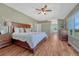 Spacious primary bedroom with en suite bathroom, hardwood floors, and natural light at 17050 Park Trail Dr, Monument, CO 80132