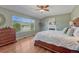 Comfortable main bedroom with fireplace, large window, hardwood floors, and mountain views at 17050 Park Trail Dr, Monument, CO 80132