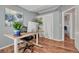 Office area with hardwood flooring, a modern desk, and a large potted plant at 17050 Park Trail Dr, Monument, CO 80132