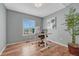 Office area with hardwood flooring, a modern desk, a large window, and an art piece at 17050 Park Trail Dr, Monument, CO 80132