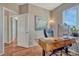 Bright home office with hardwood floors, modern desk, and natural light from the window at 17050 Park Trail Dr, Monument, CO 80132