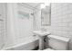 A classic bathroom featuring white subway tile, pedestal sink, and updated fixtures at 2777 S Adams St, Denver, CO 80210
