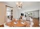 Dining area with a modern light fixture, hardwood floors, and views of the living room and kitchen at 2777 S Adams St, Denver, CO 80210