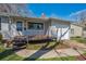 Charming single-story home with a covered front porch, well-maintained lawn, and an attached single car garage at 2777 S Adams St, Denver, CO 80210