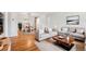 Bright living room with hardwood floors, neutral decor, and a separate dining area, creating an inviting and open space at 2777 S Adams St, Denver, CO 80210