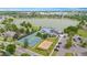 Aerial view of the community amenities near the lake, including pool, tennis courts, volleyball, and playground at 1181 E 130Th Pl, Thornton, CO 80241